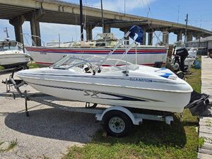 Glastron SX 175 2004 Glastron SX 175 boat on trailer near a bridge, ready for water adventures.