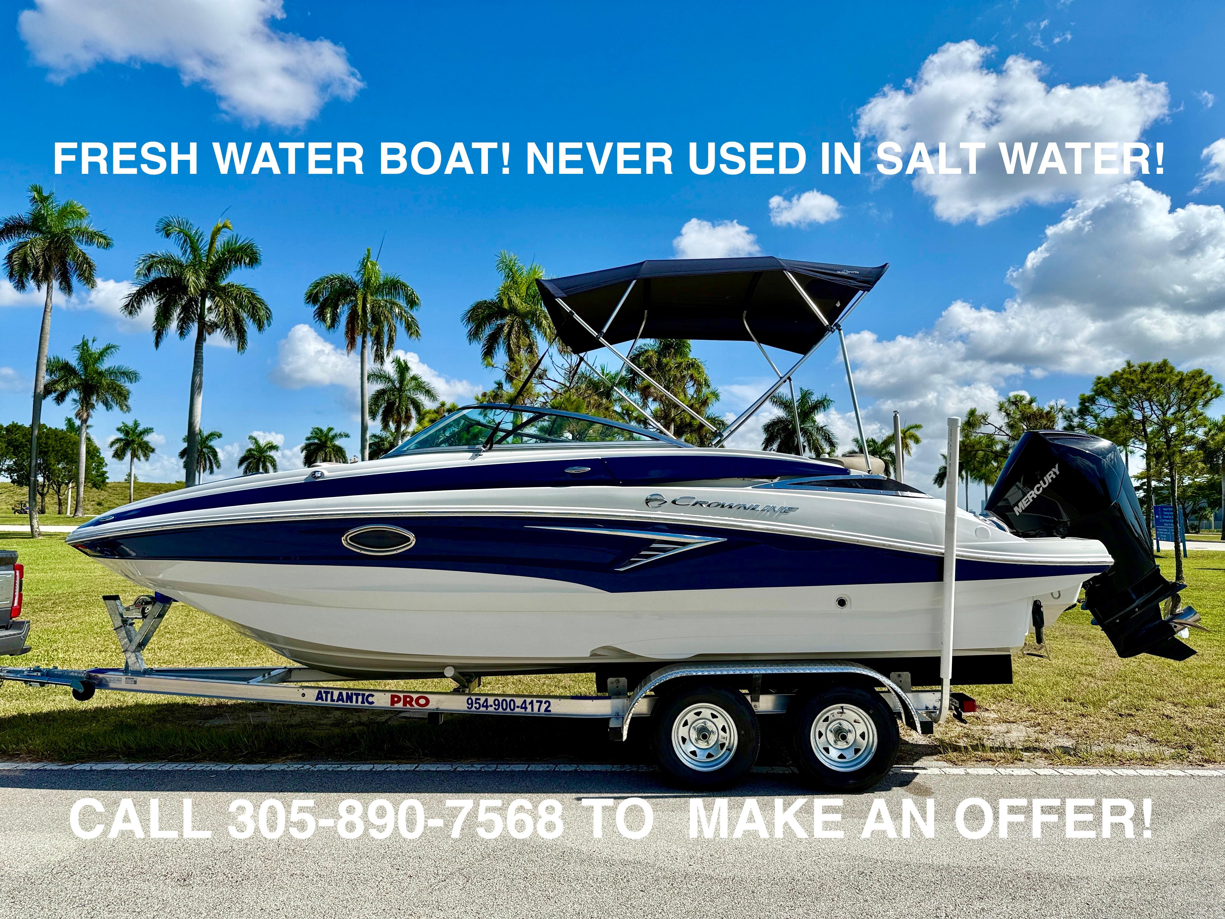 Crownline Eclipse E235 XS 2022 Crownline Eclipse E235 XS boat on trailer, fresh water use only, palm trees background.