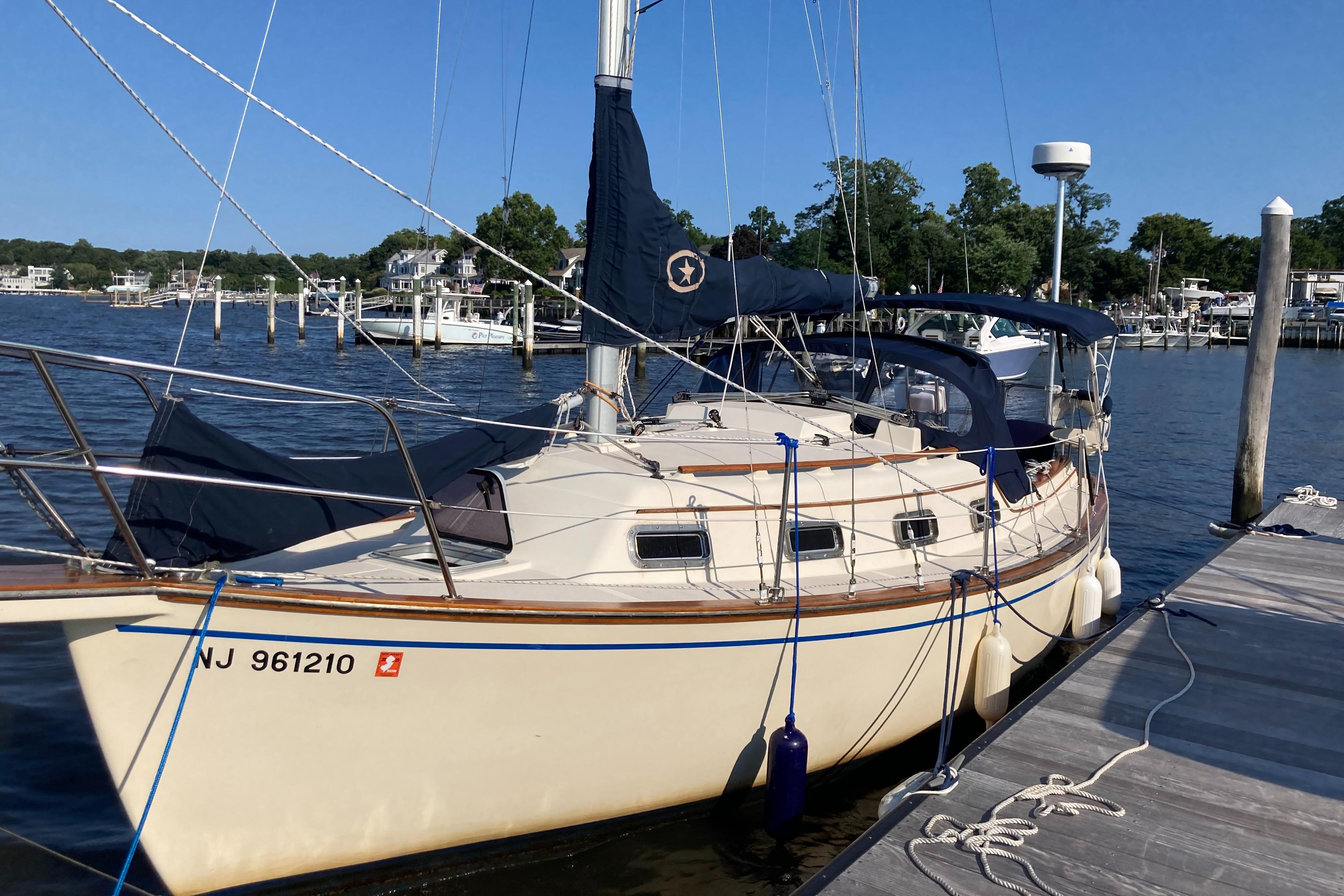 Island Packet 27 1990 Island Packet 27 sailboat docked at a marina on a sunny day.