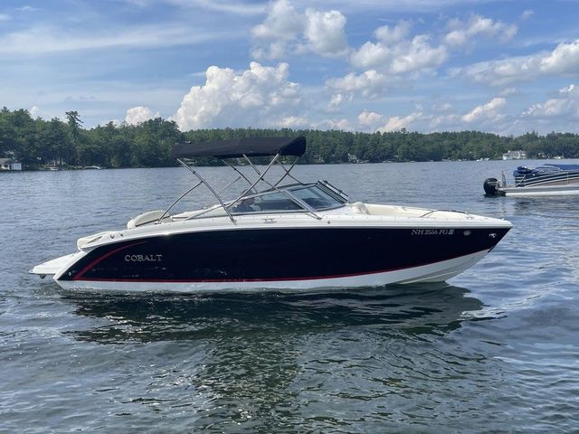 Cobalt R5 2019 Cobalt R5 boat on a lake under a partly cloudy sky.