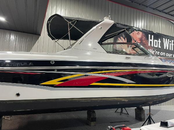 Formula 330 Sun Sport 2006 Formula 330 Sun Sport boat with colorful graphics in a showroom.