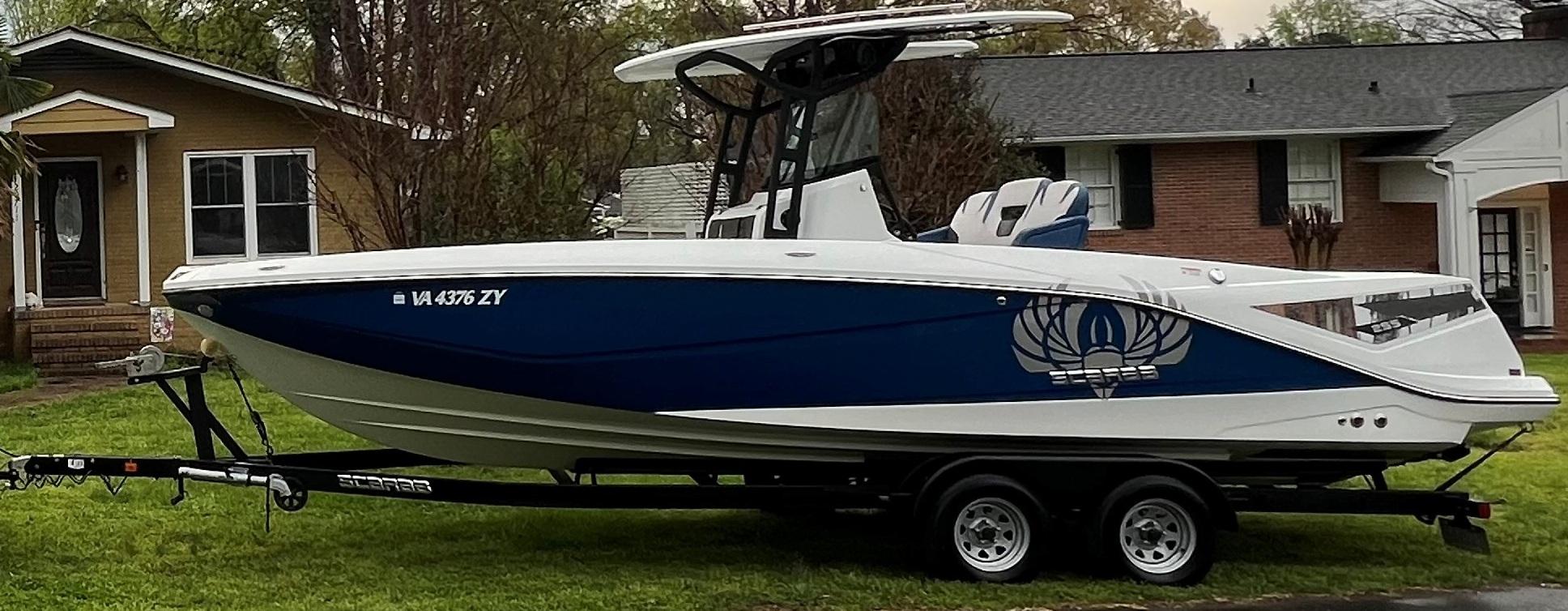 Scarab 255 Open ID 2021 Scarab 255 Open ID boat on trailer, parked in residential area.