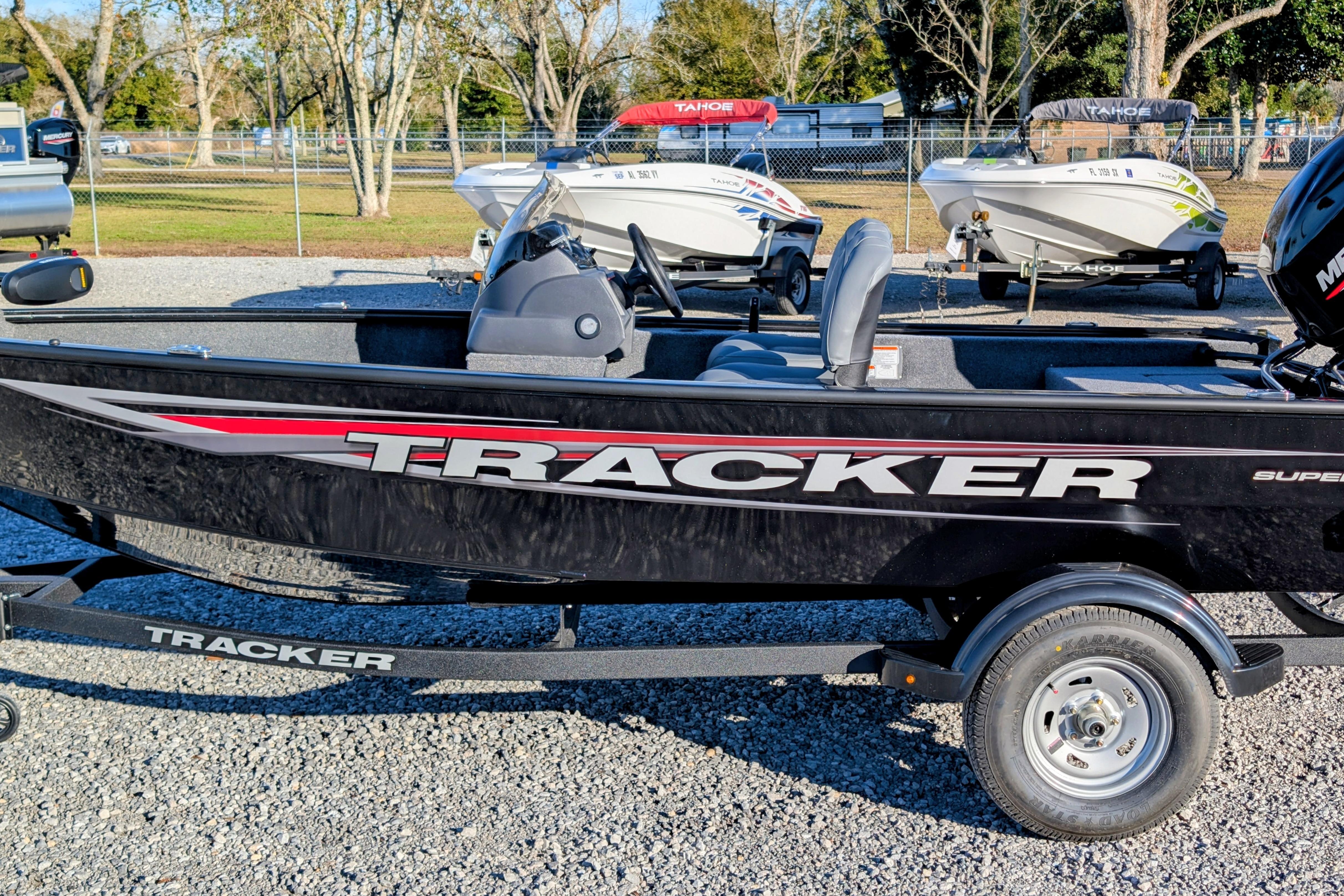 Tracker Super Guide V-16 SC 2026 Tracker Super Guide V-16 SC boat on display in a parking lot.