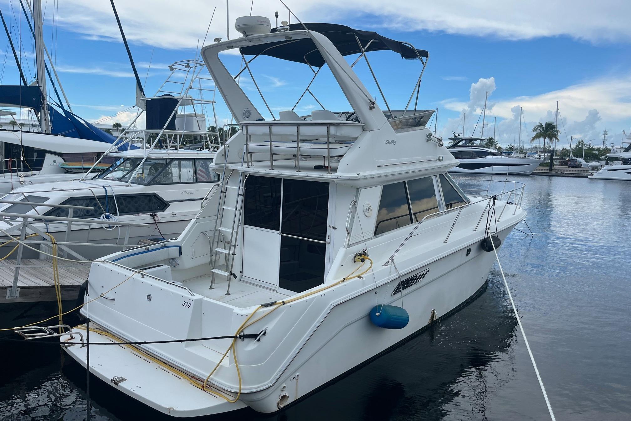 Sea Ray 370 Sedan Bridge 1996 Sea Ray 370 Sedan Bridge yacht docked at marina under blue sky.