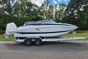 Crownline Eclipse E240 XS 2024 Crownline Eclipse E240 XS boat on trailer, parked outdoors.