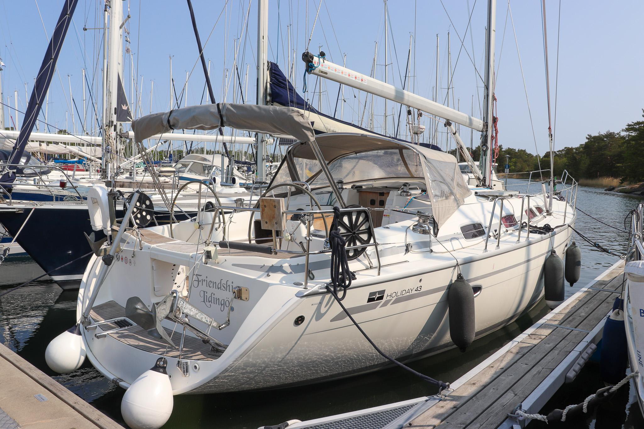 Bavaria 43 Holiday Sailing yacht Bavaria 43 Holiday 2010 docked at marina, surrounded by other boats.