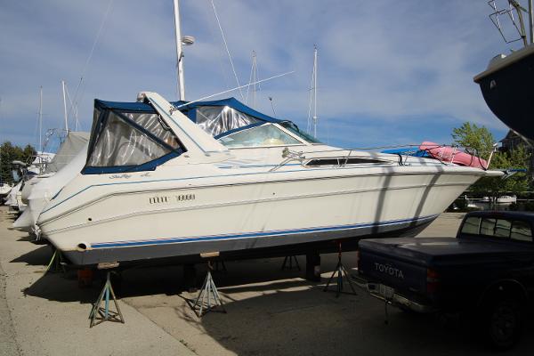 Sea Ray 330 Sundancer Boat is outside on jackstands