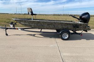 Tracker Grizzly 1654 T Sportsman 2026 Tracker Grizzly 1654 T Sportsman boat on trailer, camo design, Mercury outboard motor.