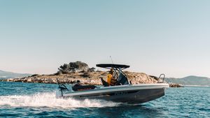 Highfield ADV7 2025 Highfield ADV7 boat cruising on clear blue water near rocky island.