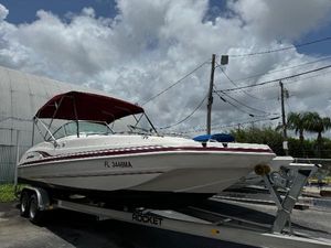 Hurricane FunDeck GS 232 OB 1999 Hurricane 232 Fun Deck boat on a trailer with a red canopy.