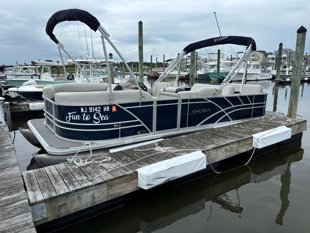 Sylvan Mirage 8522 Resorter 2022 Sylvan Mirage 8522 Resorter pontoon boat docked at marina, labeled "Fun to Sea."