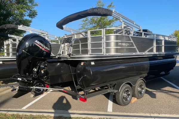 Ranger Reata 223C 2024 Ranger Reata 223C pontoon boat with Mercury outboard engine on trailer.