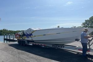 Cigarette Top Gun T/S 38 2000 Cigarette Top Gun T/S 38 speedboat on trailer at boat launch.