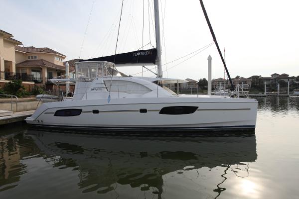 Leopard 44 Sailing catamaran Leopard 44, 2012 model, docked in a serene marina setting.