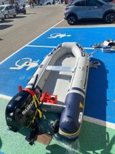 Vetus VB330 2024 Vetus VB330 inflatable boat with Suzuki outboard motor in a parking lot.