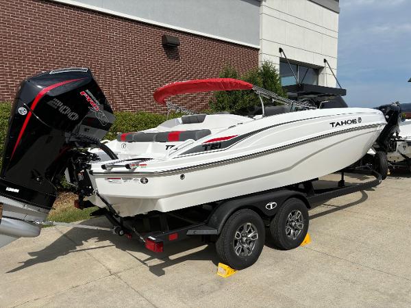 Tahoe T21 2025 Tahoe T21 boat on trailer, parked outdoors near a brick building.