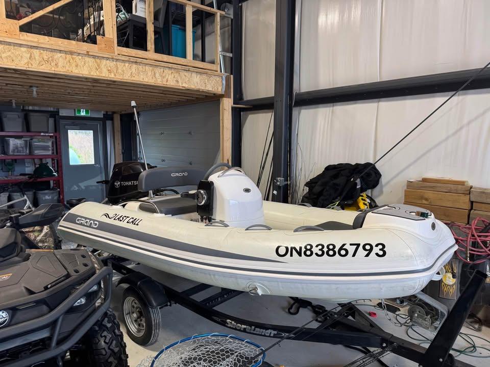 Grand G 340 2019 Grand G 340 inflatable boat on trailer in garage.