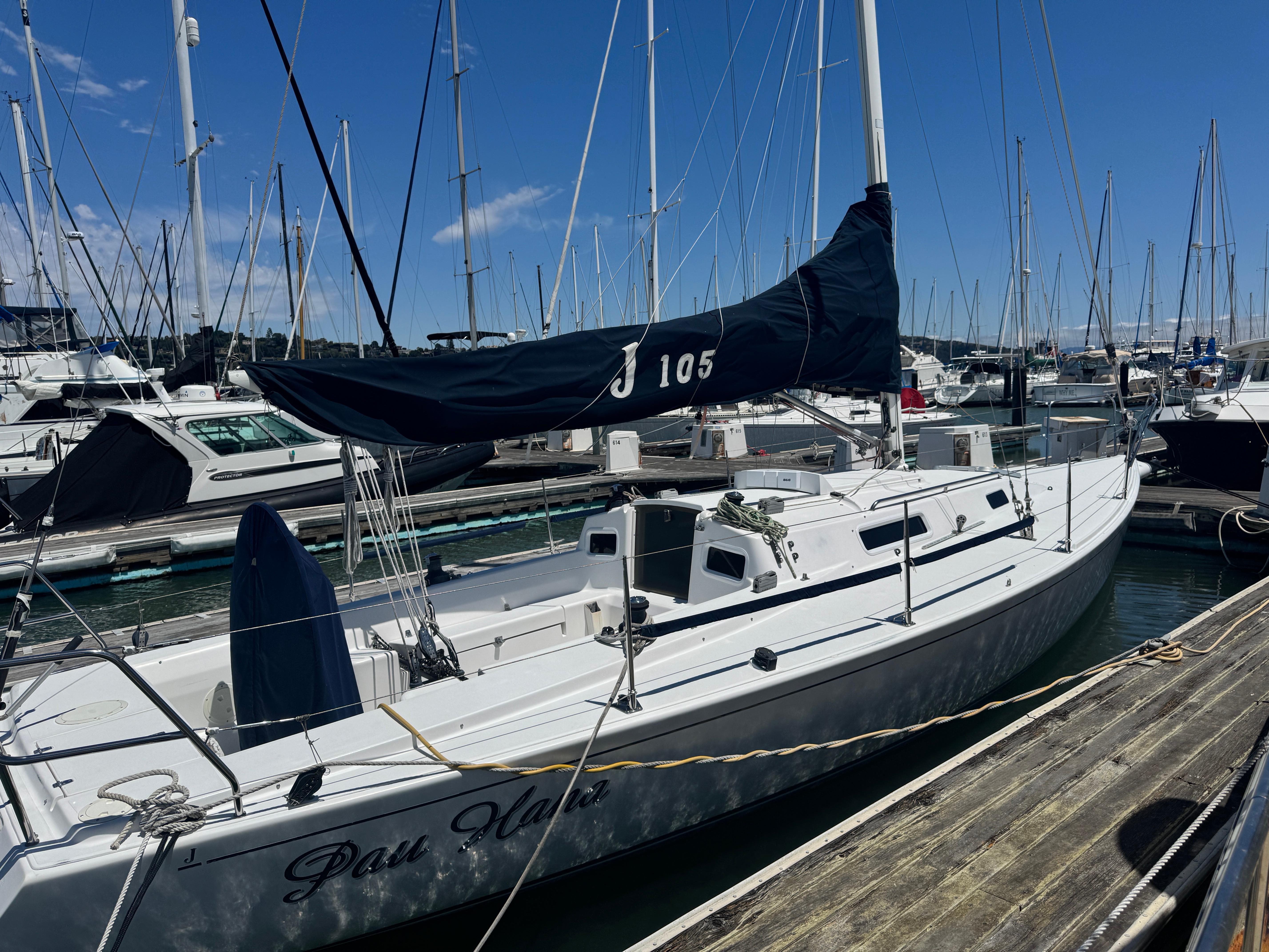J Boats J/105 2001 J Boats J 105 sailboat docked at marina under clear blue sky.
