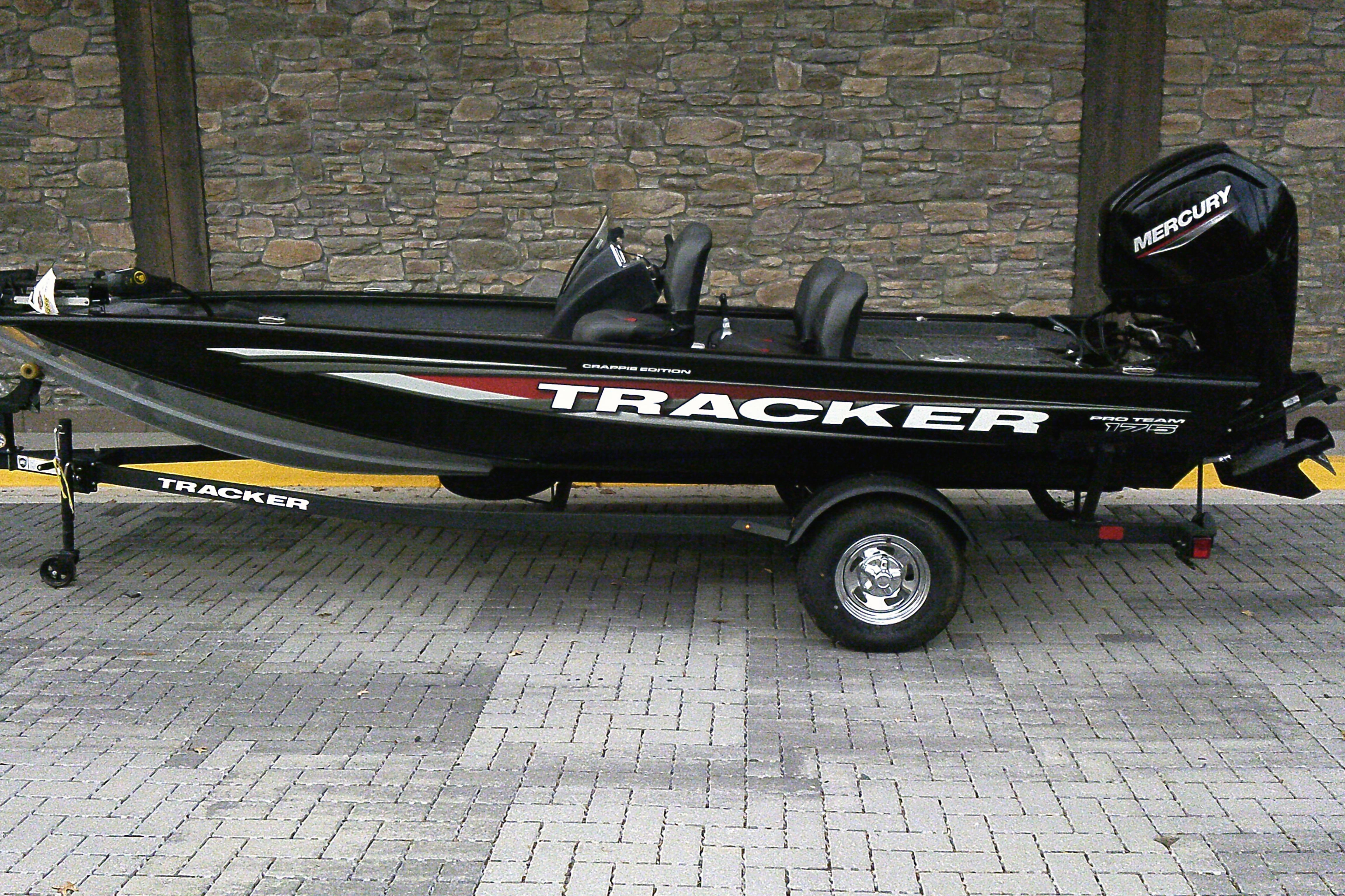 Tracker Pro Team 175 Crappie Edition 2026 Tracker Pro Team 175 Crappie Edition boat on trailer, side view.