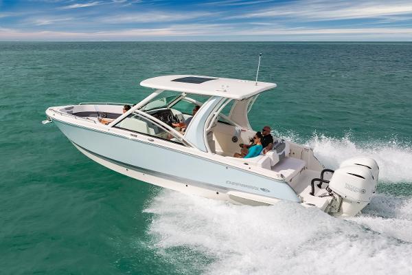 Chaparral 300 OSX 2020 Chaparral 300 OSX boat cruising on open water, showcasing sleek design and powerful engines.