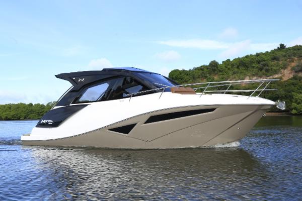 NX Boats 370 HT 2025 NX Boats 370 HT cruising on a serene lake with lush greenery.