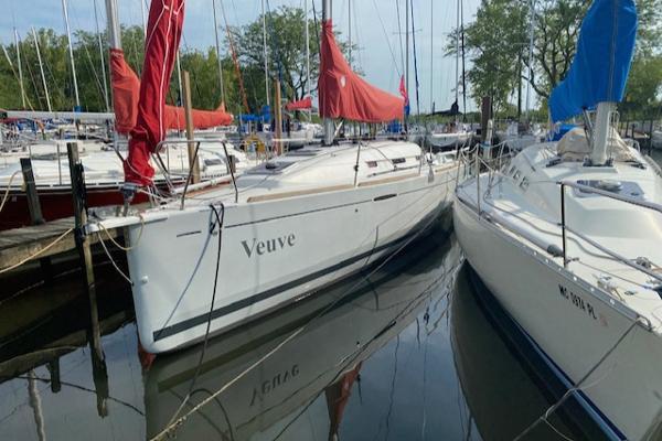 Beneteau First 30 2012 Beneteau First 30 sailboat docked, featuring red and blue sail covers.