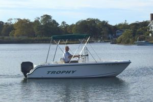 Trophy 1703 Center Console 2008 Trophy 1703 Center Console boat cruising on a calm lake with trees in the background.
