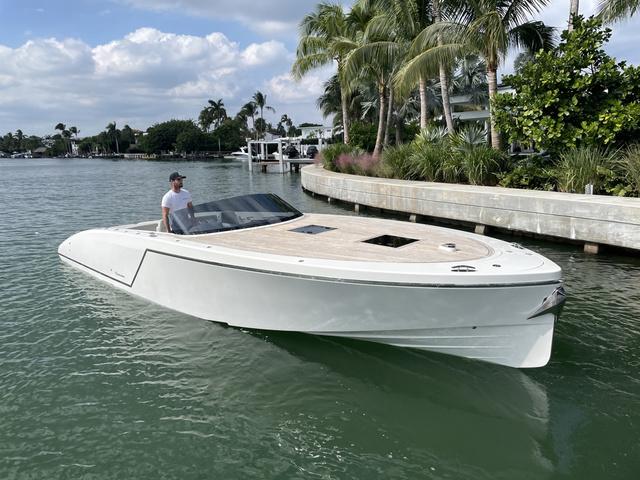 Frauscher 1017 GT 2020 Frauscher 1017 GT luxury boat cruising near tropical shoreline.