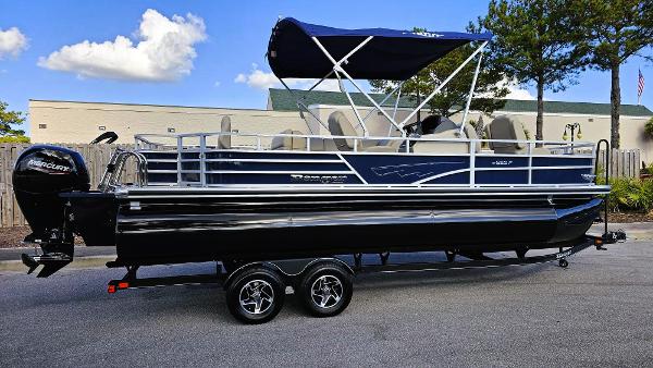 Ranger Reata 223F 2024 Ranger Reata 223F pontoon boat with canopy on trailer, parked outdoors.