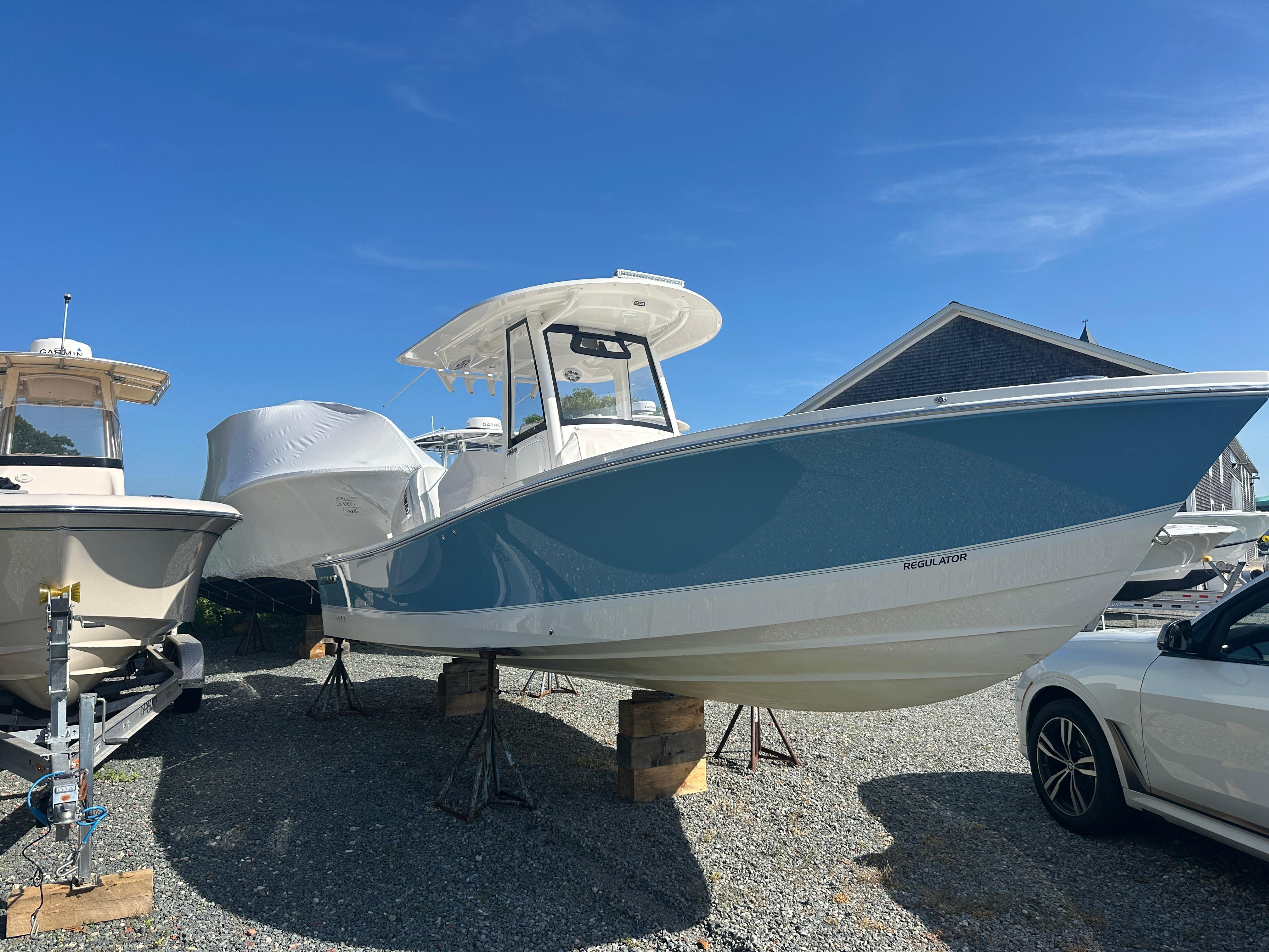 Regulator 26XO Center Console 2021 Regulator 26XO Center Console boat displayed outdoors on stands.