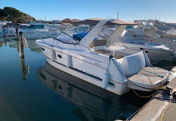 Jeanneau Leader 8 2014 Jeanneau Leader 8 boat docked in a marina, reflecting on calm water.