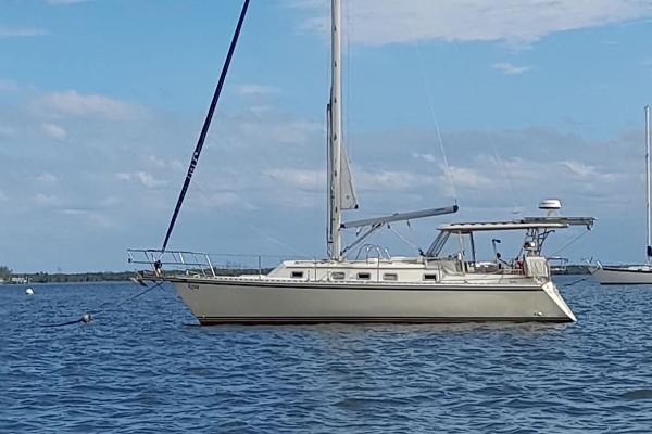 Caliber 35 Sailboat Caliber 35, 1993 model, anchored on calm blue waters under a clear sky.