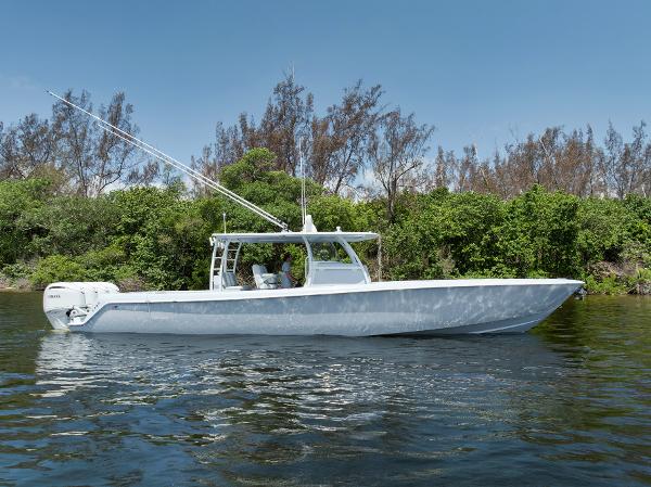 Contender 44 ST 2025 Contender 44 ST boat on calm water, surrounded by lush greenery.