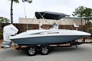 Tahoe 2150 CC 2026 Tahoe 2150 CC boat on trailer with Mercury engine, parked outdoors.