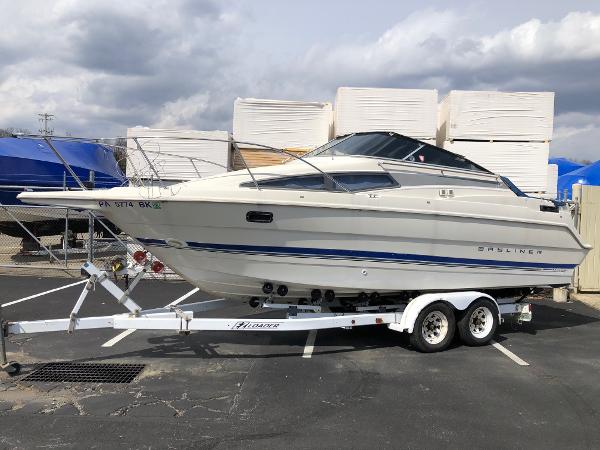 Bayliner 2655 Ciera 1994 Bayliner 2655 Cierra boat on a trailer in a parking lot.