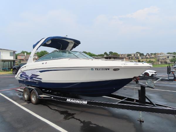 Chaparral 267 SSX 2012 Chaparral 267 SSX boat on a Magnum trailer in a parking lot.