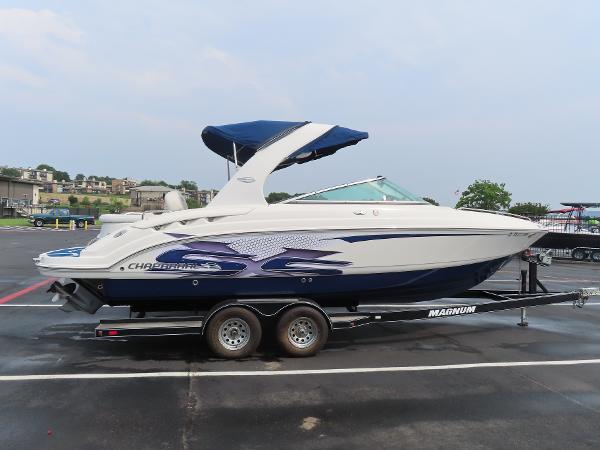 Chaparral 267 SSX 2012 Chaparral 267 SSX boat on a trailer in a parking lot.