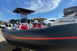 Nuova Jolly Custom 2024 Nuova Jolly Custom boat with red accents, docked under a clear blue sky.