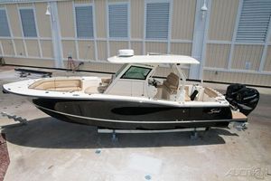 Scout 330 LXF 2022 Scout 330 LXF boat with dual Mercury outboard engines on display.