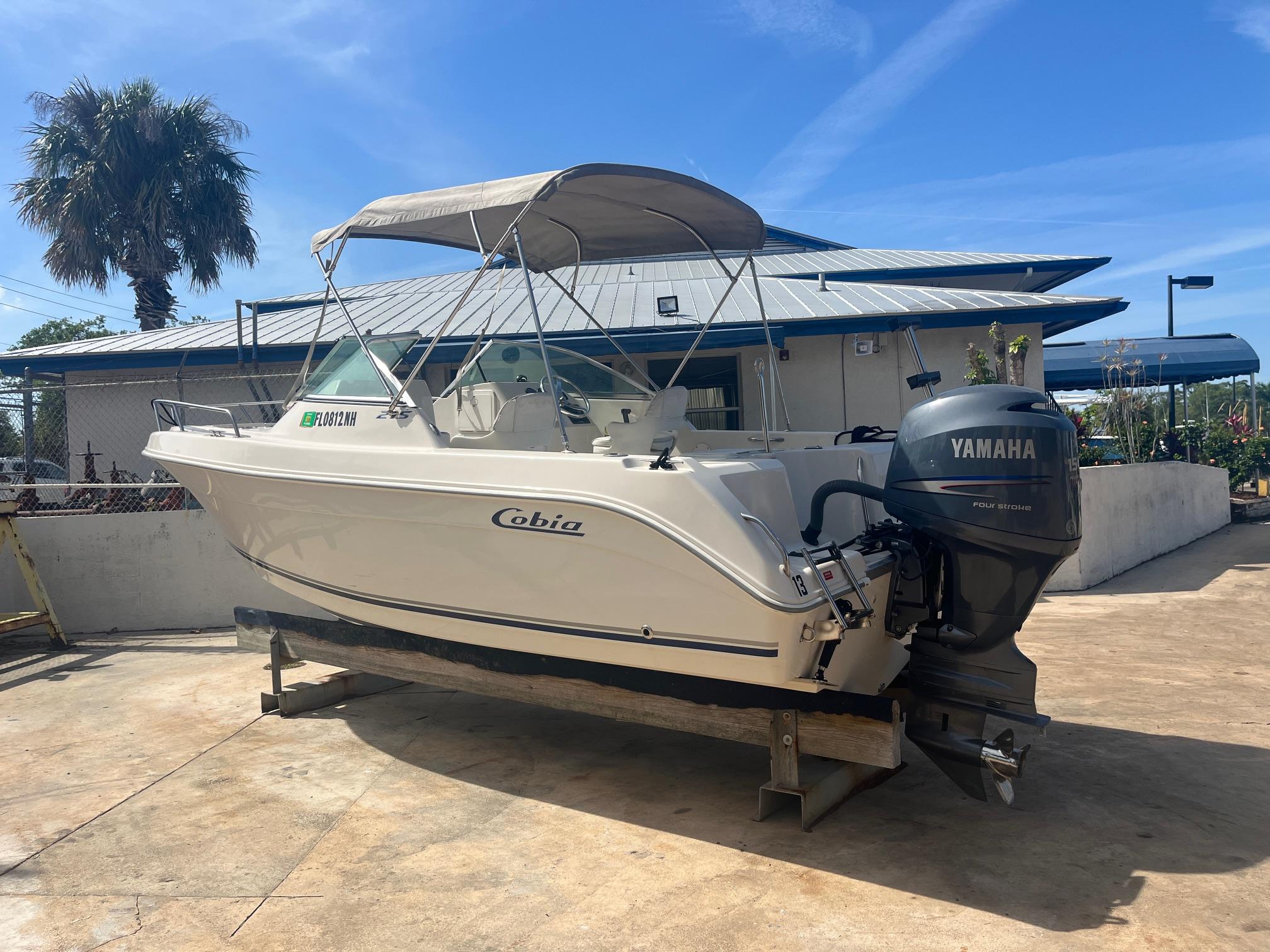 Cobia 214 2007 Cobia 214 boat with Yamaha engine on a stand, outdoor setting.