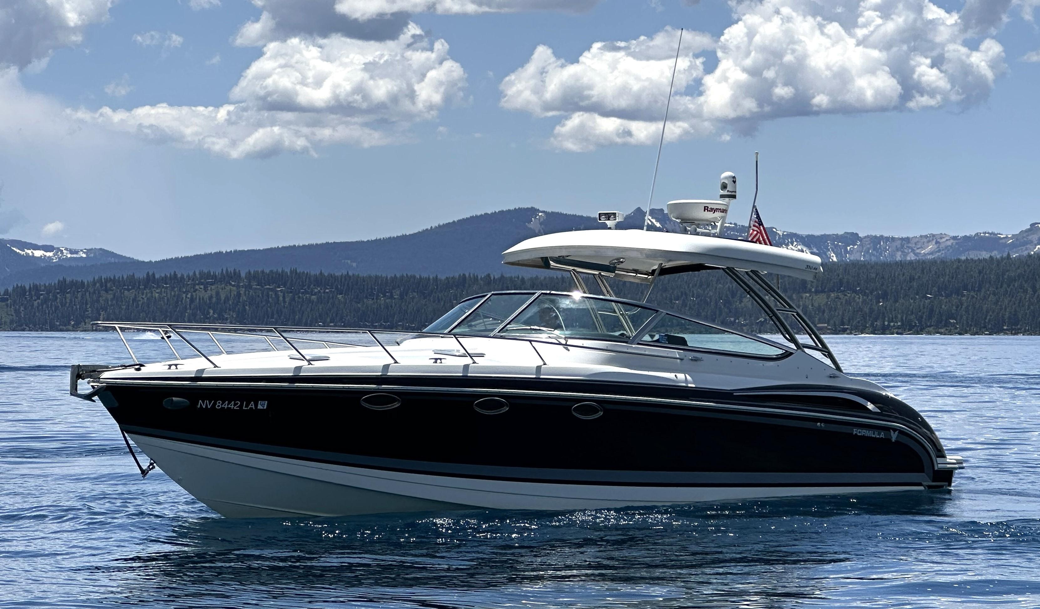 Formula 370 Super Sport 2017 Formula 370 Super Sport boat on a serene lake with mountainous backdrop.