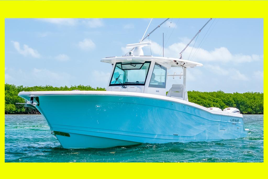 Caymas 401CC 2023 Caymas 401CC boat on clear water, bright day, lush green background.