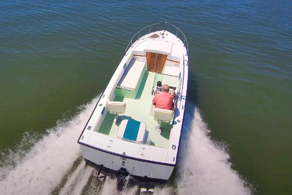 Aquasport 24 Launch 1976 Aquasport 24 Launch boat cruising on open water, aerial view.
