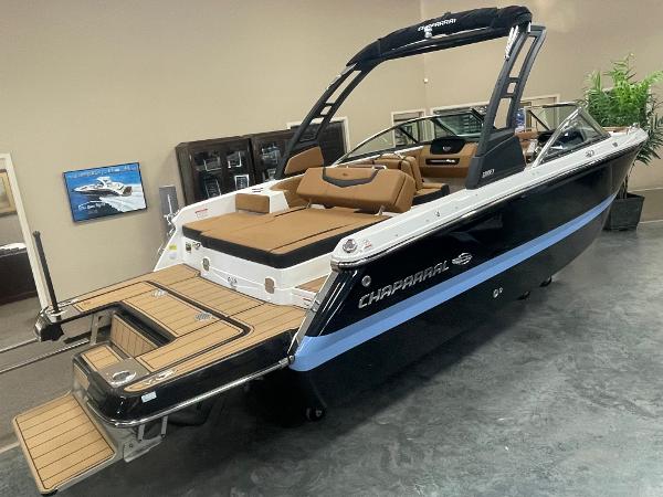Chaparral 247 SSX 2024 Chaparral 247 SSX boat in showroom, black hull, tan interior, swim platform.