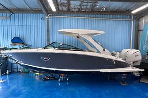 Regal LX9 2026 Regal LX9 boat in showroom, sleek design with blue hull and white accents.