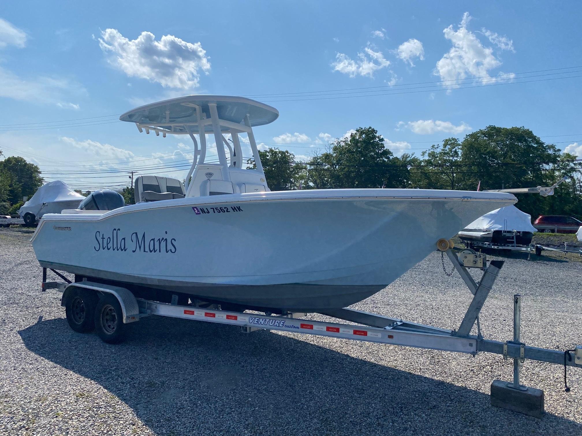 Tidewater 232 LXF 2017 Tidewater 232 LXF boat named "Stella Maris" on a trailer under a blue sky.