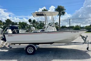 Boston Whaler 210 Montauk 2023 Boston Whaler 210 Montauk boat on trailer, parked outdoors under a clear sky.