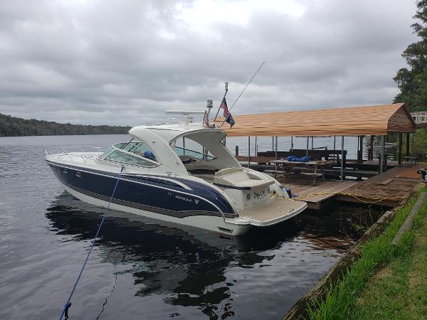 Formula 400 Super Sport 2017 Formula 400 Super Sport boat docked by a wooden pier on a cloudy day.