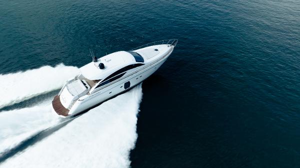 Pershing 64 2014 Pershing 64 yacht cruising swiftly on open water.
