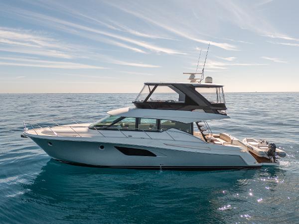 Tiara Yachts F53 Flybridge 2017 Tiara Yachts F53 Flybridge cruising on calm ocean waters.